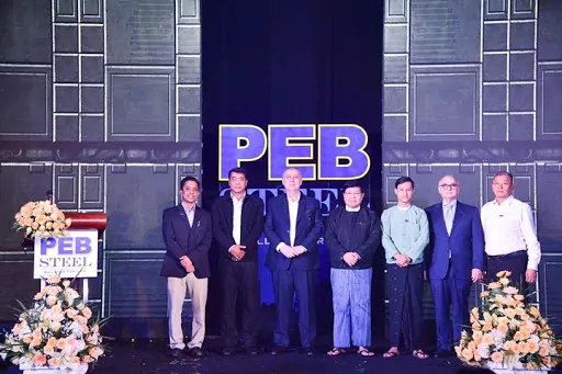 PEB Steel's board of directors take a picture with the delegates