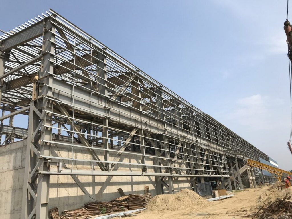 The steel frame structure comprises upright steel columns, horizontal steel beams, and steel connections that help assemble the components together.