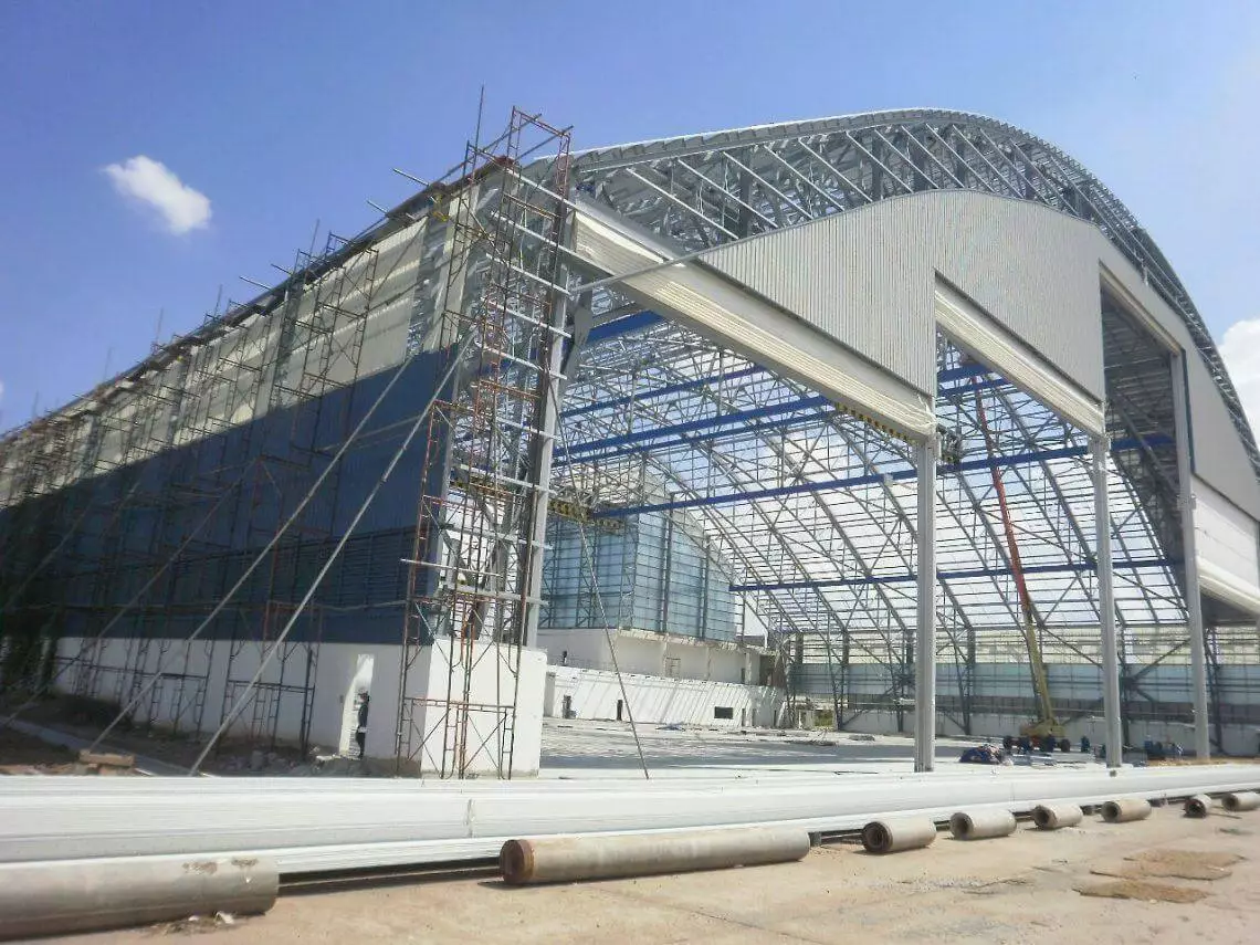 Aircraft hangar constructed using curved built-up rafters by PEB Steel