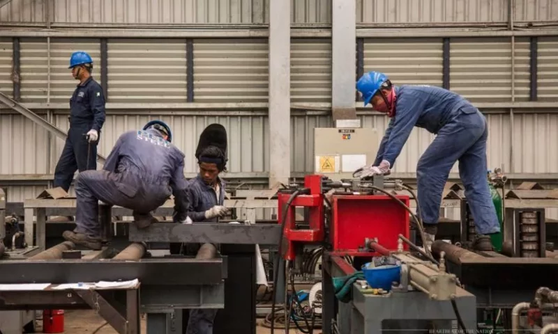 Pebsteel workers are performing the steel cutting process by machine