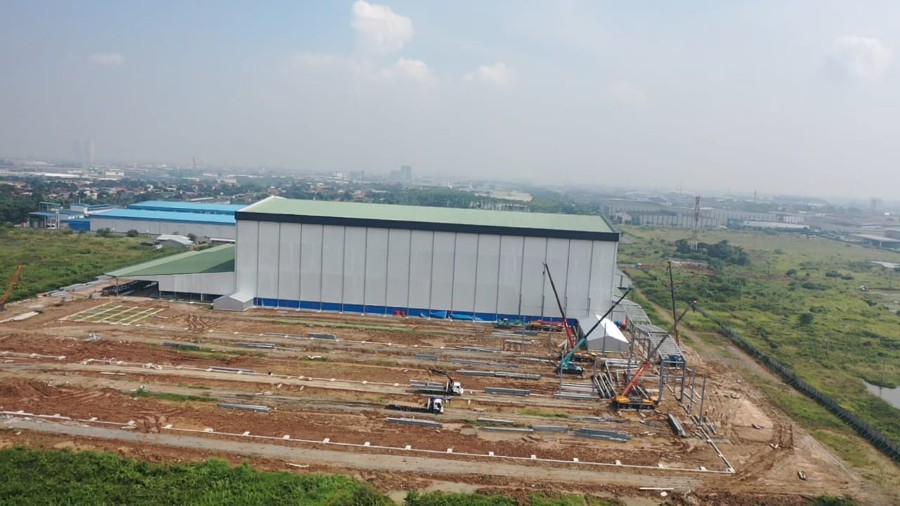 The prefabricated steel building is in the first stages of construction.